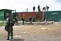 U.S. Marines from 26th Marine Expeditionary Unit (Special Operations Capable) secure the Freeport of Monrovia on Bushrod Island in Liberia during the Second Liberian Civil War. The 26th MEU (SOC) conducted a helicopter-borne landing at the port on August 15, 2003.