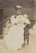 Prince George held by his brother, the future King Edward VIII