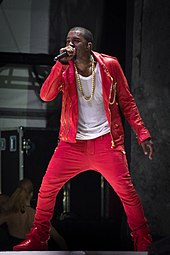 A Man wearing a red outfit and is holding a microphone