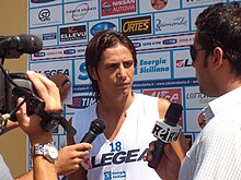 A photo of Marco Biagianti being questioned by sports reporters at the Massannunziata Sports Centre.