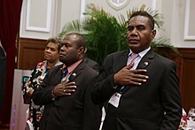 Herming (right) puts his right hand over his heart during a state dinner as part of a state visit led by Prime Minister Sogavare (26 September 2017) in Taipei, Taiwan