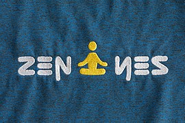 "Zen Yes" embroidered on a blue T-shirt with a meditation symmetrical pictogram.