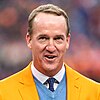 Headshot of Peyton Manning wearing a suit