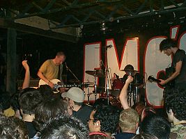 Fugazi performing at Emo's in 2002; left to right: Ian MacKaye, Brendan Canty and Guy Picciotto (not pictured: Joe Lally)