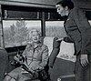 Zephyrette Nellie O'Grady interacting with a passenger in 1956