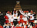 The Calgary Dinos hoist the Vanier Cup trophy following their win over the Montreal Carabins in 2019.