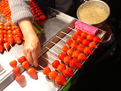 Strawberry dipped with sugar coating for sale as a bingtang hulu (2004)