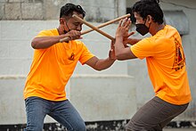 2 opponents armed with sticks facing each other, during Eskrima fight. Photo: Budots Media / Bart Sakwerda