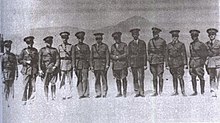 A black-and-white photograph of 12 military officers in early-20th century military dress uniform standing side-by-side and facing the camera