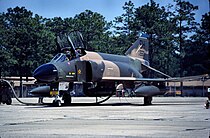 A U.S. Air Force F-4 Phantom II pictured at Tinker Air Force Base. On its intake splitter-plate is a kill mark in the form of a red star, signifying an aerial victory achieved during the Vietnam War.