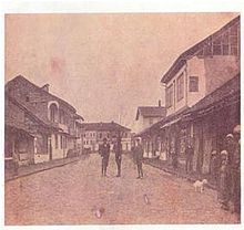 Street with three people standing in the middle