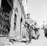 Parachute Regiment soldiers in Aden in 1956 wearing khaki drills and berets, with carrying equipment stripped to ammunition pouches.