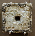 A plaque made out of alabaster and asphalt (dated to c. 2500 – c. 2330 BCE)