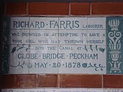 A tablet formed of six standard sized tiles, bordered by green flowers in the style of the Arts and Crafts movement