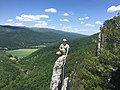 Climber on top of "Bring on the nubiles", west face of Seneca Rocks