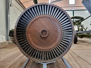 This rear view of a Klimov VK-1 turbojet shows the parts responsible for turbine temperature overshoot after increasing thrust from idle to take-off, known as transient EGT overshoot.[124] Visible is the turbine blade tip clearance which is a leakage path for gas which doesn't contribute to the power developed by the turbine. Increased gap, and leakage, means more fuel, indicated by a higher EGT, is required to get take-off thrust. Clearance is increased temporarily every time the engine goes from idle to take-off because the light casing expands quickly to the turbine gas temperature but the heavy turbine rotor takes minutes to expand to its hot diameter.
