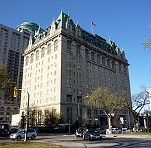 Exterior photo of a ten-storey hotel constructed in châteauesque architecture, feature grey granite walls and a copper roof
