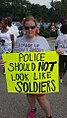 A person protesting against the militarization of police, August 17