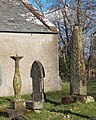 View of sundial and both the standing and fallen cross shafts. The fallen shaft is at the foot of the sundial.