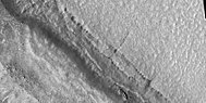 Close view of pits and boulders along crater wall, as seen by HiRISE under HiWish program