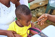 Picture of a child held while being vaccination
