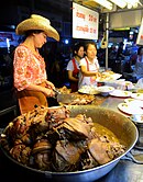 Ham hocks stewed in soy sauce and five-spice powder at a street stall in Chiang Mai, Thailand