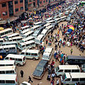 A queue of Matatus (minibus taxis) push to get into the taxi park in Kampala, Uganda. Part of the series Nairobi to Cape Town.