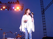 Country music singer Pam Tillis, singing into a microphone