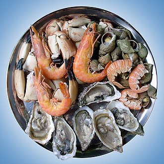 A seafood platter composed of shrimp, oyster, snail and crab.