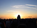 Sun rising behind the Heel Stone at Stonehenge