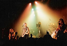 The Cross on stage in Germany, 1990. L-R: Clayton Moss, Roger Taylor and Peter Noone.