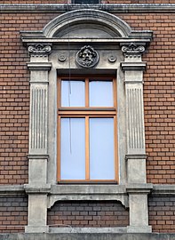 Window with pilasters, pediment and mascaron