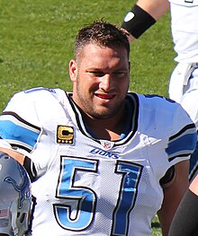 Dominic Raiola in a Detroit Lions uniform smiling, revealing his mouth guard.