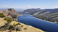 Wide river with sloped landscape on both sides,