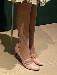 A pair of knee-high boots with light brown shaft and pink vamp/upper and heels.
