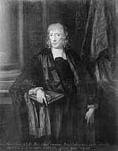 A man with light-coloured, slightly curly, hair. He is wearing black clothes and a black gown, and holds a large book in his right hand