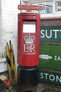Type K pillar box of Elizabeth II fitted with a "Post Office Direction" sign