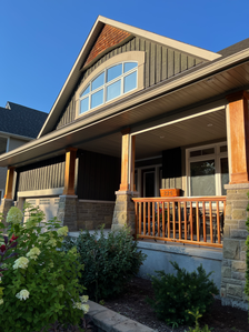 a) Board-and-Battan siding,[72] b) Square-post ornamentation,[85] c) Shingle-style, gable apex ornamentation,[86] d) Front verandah[83] (built, 2006)