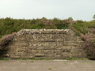 Mass grave for people killed at Bergen-Belsen concentration camp. The engraving says "Here rest 5,000 dead. April 1945."