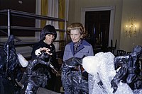 Ford and Social Secretary Maria Downs inspect centerpiece sculptures designed by Frederic Remington and Charles Russell ahead of an October 1975 state dinner honoring Anwar Sadat, the president of Egypt.