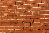 Defective pointing can allow rain to penetrate through masonry walls.