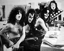 Paul Stanley, Gene Simmons, Peter Criss, and Ace Frehley looking towards a camera