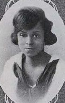A young Black woman wearing a sailor-style middy blouse, in an oval frame