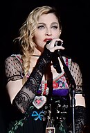 Madonna singing with a mic in her hand.
