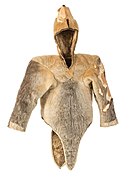 A fawn-brown and grey waist-length fur cape, with long sleeves and a hood. Sealskin woman's parka discovered at Qilakitsoq in 1972, dated to c. 1475.
