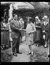 Everett Sanders shaking hands with Spelling Bee champion Betty Robinson