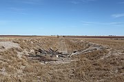 The Fort Worth and Denver South Plains Railway used to pass through Becton. The collapsed remains of a wooden railway overpass can be seen at the bottom of the roadcut.