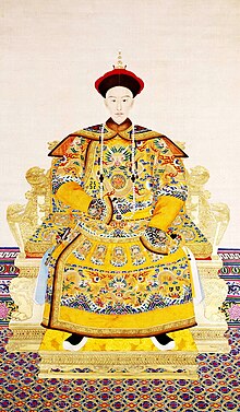 A portrait of the Guangxu Emperor seated on a throne in a yellow robe