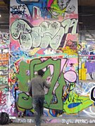 A graffiti artist at work in London