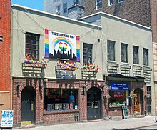 The exterior of Stonewall Inn in 2012, with a LGBT rights sign above the entrance
